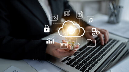 A business professional engaged with a laptop displays cloud icons and a light bulb, representing innovation, data security, and modern technology solutions effectively. Gantry