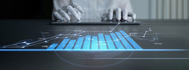 Close-up of hands operating a digital tablet showcasing a vibrant data visualization with bar graphs and dynamic trends in a professional office environment. Scalp