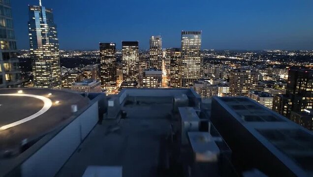Nighttime Cityscape View from Rooftop Helipad in Urban Setting.