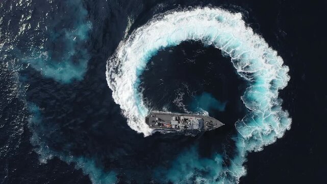 Israeli Navy Fast Patrol Boat Maneuver

Aerial view of an Israeli Navy fast patrol boat performing a sharp high-speed turning maneuver, creating a circular wake pattern on open sea, Israel, November 2
