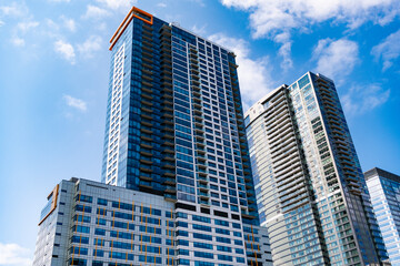 Obraz premium Glass reflective skyscraper. City architecture. Architecture office building. Perspective skyscraper. Minimalist glass architecture. Business skyscraper building. Architectural building business area
