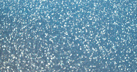 Blurred defocused background. Blur glitter backdrop. Glitter shimmer background. Defocused shimmer. Bokeh backdrop shimmer. Bokeh effect. Glitter shine. Bokeh shimmering background. Sparkling glitter