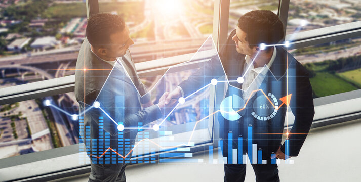 Two business professionals shake hands in a modern office, with digital graphs showcasing financial data, symbolizing growth and successful collaboration. Scalp - Powered by Adobe