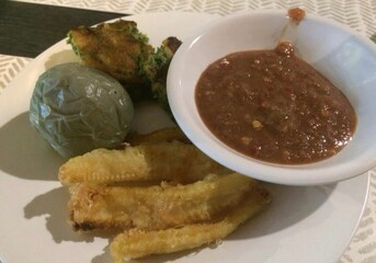 Thai, shrimp paste, chili dip, served, with blanched pea eggplant, fried baby corn, and boiled bamboo shoots&mdash;colorful, rustic, and isolated for food styling.