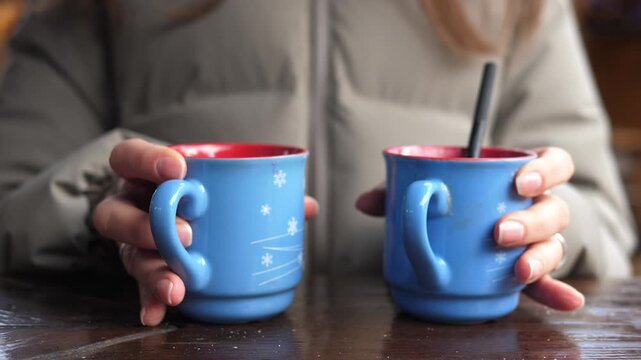 Cozy winter scene with two mugs of hot chocolate topped with whipped cream. Warm drink concept, hygge lifestyle, comfort, relaxation, and seasonal winter mood