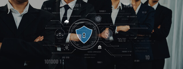 A professional team in business suits stands confidently, showcasing unity and strength while...