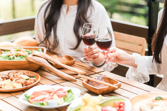 Young woman having a home party/glamping on a wooden deck