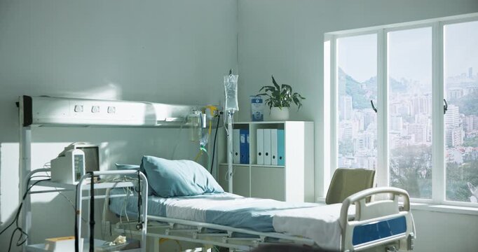 Empty bed, hospital and room for healthcare, wellness and recovery in icu with medical equipment. Clinic, interior and facility with iv drip, ECG monitor and tools for healing with rehabilitation