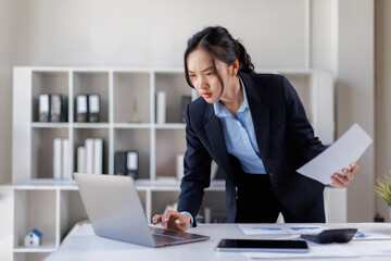 Fototapeta premium Tired stressed businesswoman feeling tired business woman sleepy and bored from sitting at a desk for a long time and has office syndrome 
