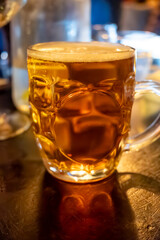 Classic London pub crawl with friends, enjoying cask ales and lively atmosphere of traditional...