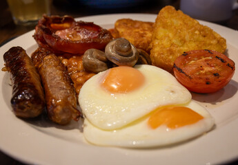 Full English breakfast with eggs, bacon, sausage, beans, toast, mushrooms, grilled tomatoes,...