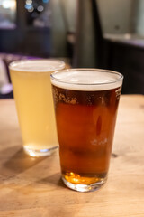 Classic London pub crawl with friends, enjoying cask ales and lively atmosphere of traditional British pubs, grasses of cask ales beer from barrels