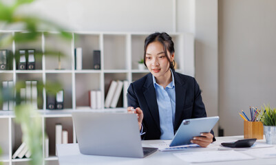 Business asian woman working at office with tablet and document, doing planning analyzing the financial report Tax Advisory Firm.
