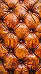 Fototapeta premium Detailed, close-up view of a vintage, orange-brown leather buttoned upholstery. Intricate diamond pattern