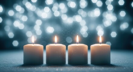 Four white candles burning brightly against a sparkling blue bokeh background