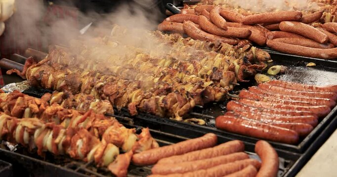 Krakow Poland Old Town Christmas meat turn. Annual Christmas market celebration party night. Food, rides, events city town square. Historical. population center in southern Poland. Food BBQ.