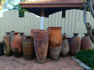 Traditional clay pottery jars displayed outdoors, showcasing rustic textures, handmade craftsmanship, and natural earth tones.