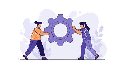 Two women working together to turn a large gear