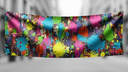 A banner with colorful paint splatters, suspended in front of a blurry, grayscale street scene