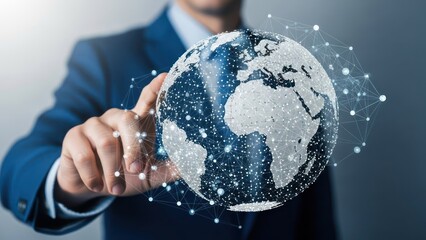 A person in a suit points to a digital globe with network connections overlaid