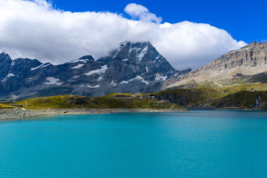 Lago Goillet alpine reservoir below peaks - Valtournenche, Italy