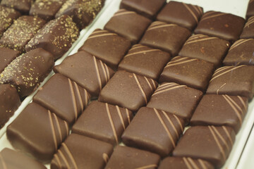 Chocolate pieces arranged on a display tray in a shop