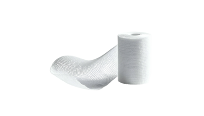 Roll of white medical bandage with some unravelled, against a black backdrop