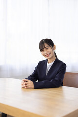 Young Businesswoman Smiling at Desk in Bright Office