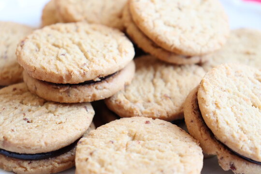 Pile of oatmeal fruit cookie. Tender biscuit, scone or oatcake. Raspberry soft cookie and snack and treats. Desserts and festive treats.