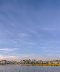 Obraz premium Clouds and blue sky over homes and Oquirrh Lake
