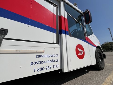 Low-angle view of a Canada Post delivery truck - Vue en contre plong&eacute;e d'un camion de livraison de Postes Canada