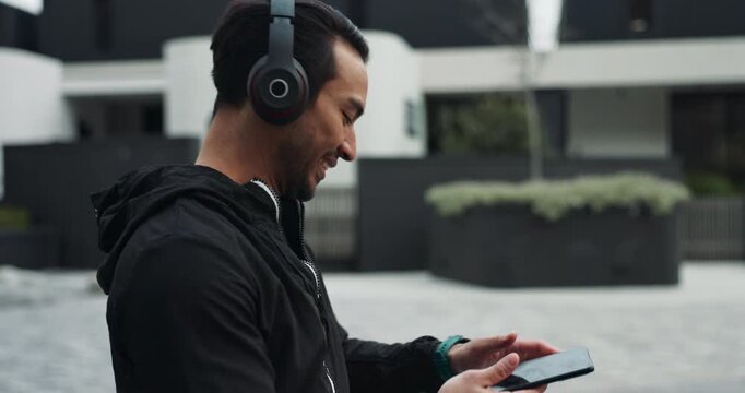 Fitness, man and phone with headphones for running in neighborhood with morning cardio, exercise and radio. Smartphone, happy and streaming subscription for podcast, music and favorite song outdoor