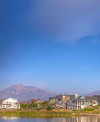 Oquirrh Lake with homes against mountain and sky