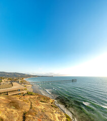 Palm trees and Pier on Manhattan Beach at sunset in California, Los Angeles, USA.