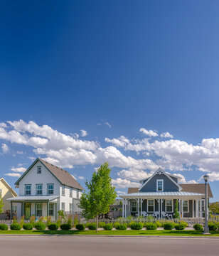 White and blue houses with puffy clouds
