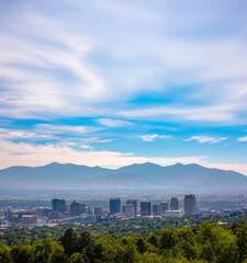 Salt Lake City with skyscrapers mountain and trees