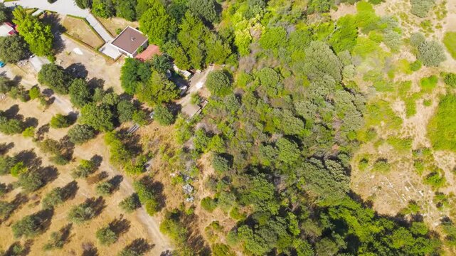 Tevfikiye, Turkey. Odeon concert hall and ruins of the Roman settlement Troy IX at the archaeological site of ancient Troy. Aerial view, MasterShots, Fly Forward - Roll, Tilt up