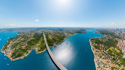 Istanbul, Turkey. Fatih Sultan Mehmet suspension bridge over Bosphorus Strait connecting Europe and Asia on sunny summer day. Aerial view