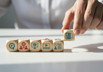 Microlearning Content Strategy A human hand arranges small wooden cubes with short video icons, showing the systematic methodology for delivering bite-sized educational content for problem-solving