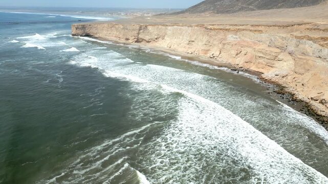 Aerial view of the coast of Eten, Lambayeque in northern Peru, with the lighthouse overlooking the Pacific Ocean and the arid coastal landscape in summer