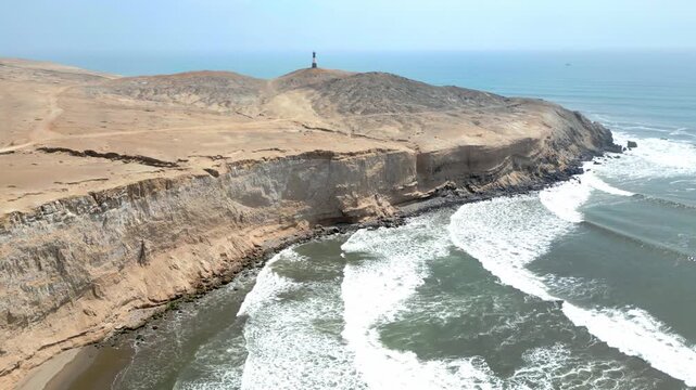 Aerial view of the coast of Eten, Lambayeque in northern Peru, with the lighthouse overlooking the Pacific Ocean and the arid coastal landscape in summer