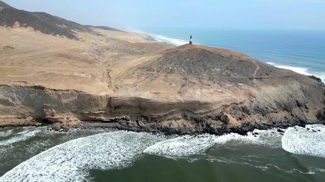 Aerial view of the coast of Eten, Lambayeque in northern Peru, with the lighthouse overlooking the Pacific Ocean and the arid coastal landscape in summer