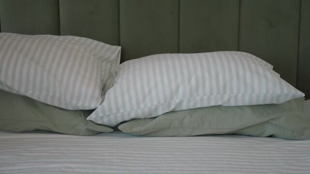 Pillows stacked neatly on a bed at home