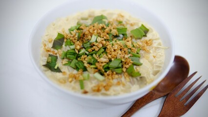 Table top view Homemade steamed egg with​ onion and fried garlic.