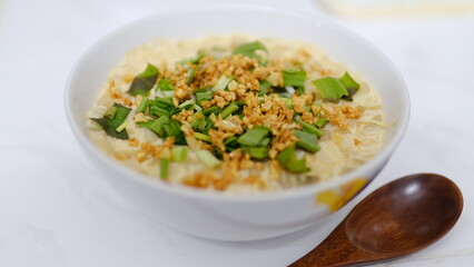Table top view Homemade steamed egg with​ onion and fried garlic.