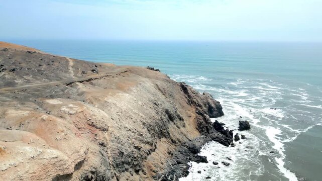 Aerial view of the coast of Eten, Lambayeque in northern Peru, with the lighthouse overlooking the Pacific Ocean and the arid coastal landscape in summer