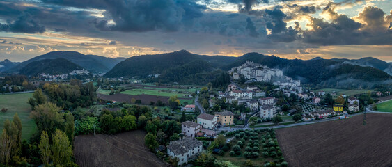Aerial view of Arrone medieval hilltop village with castle in Valnerina valley Umbria Italy Dramatic sunset sky