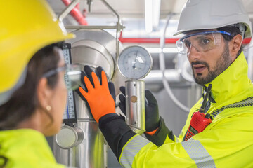 Specialized engineer monitoring building automation data for optimal thermal efficiency.