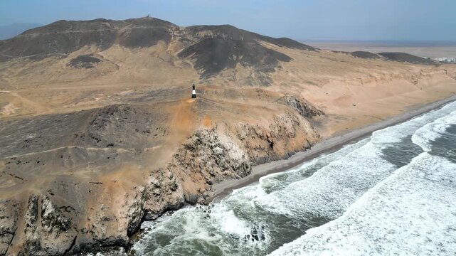 Aerial view of the coast of Eten, Lambayeque in northern Peru, with the lighthouse overlooking the Pacific Ocean and the arid coastal landscape in summer