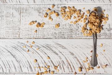 homemade granola in a spoon on a white background